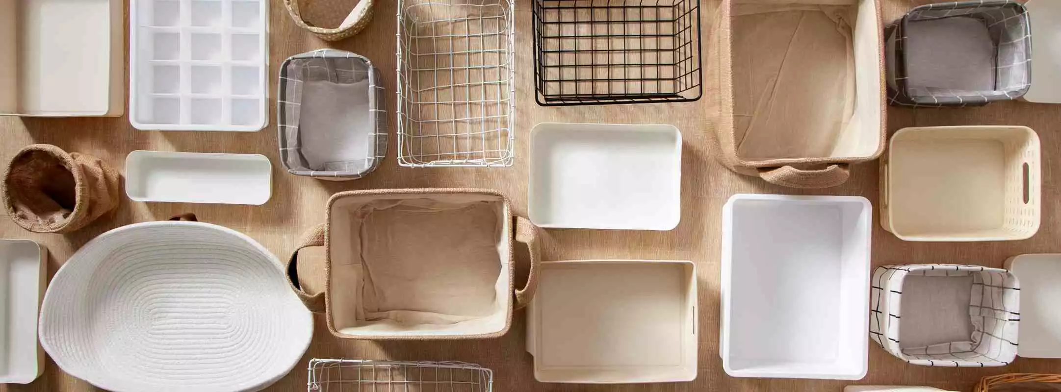 A flat lay of various storage containers in different sizes, colors, and materials.