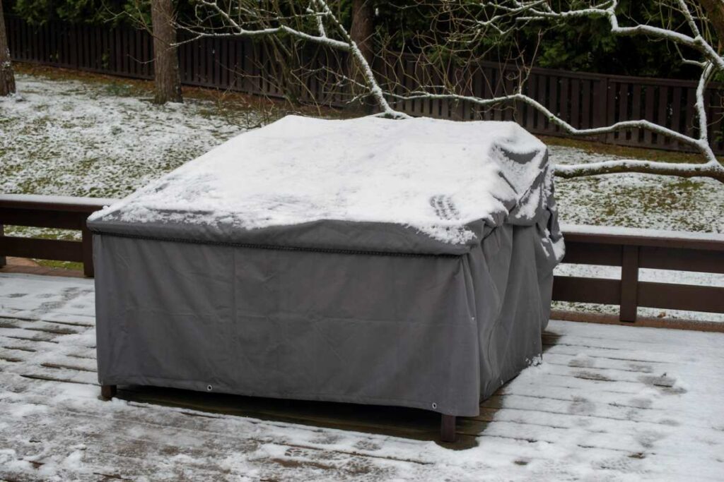 Cover protecting patio furniture from snow. 