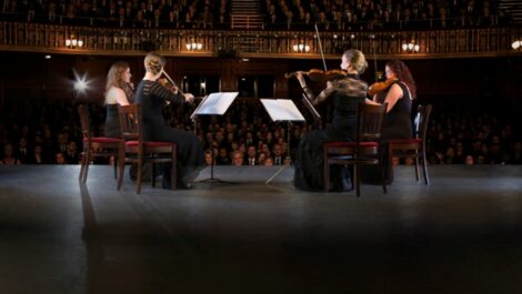 Quartet performing on stage in theater