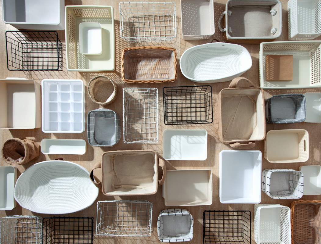 A flat lay of various storage containers in different sizes, colors, and materials.